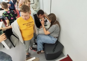 Uczniowie biorą udział w warsztatach i próbują odpowiedzieć na pytanie co się kryje w bursztynie?